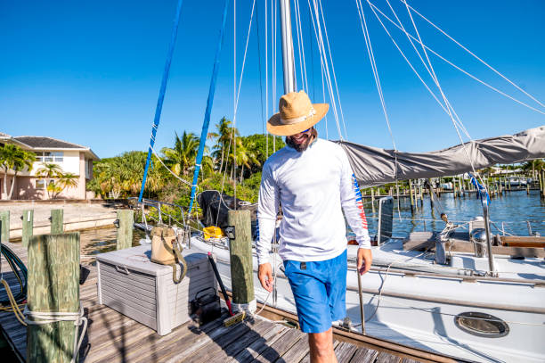 istock Handsome young middle eastern man on a sailboat dock ready for a day of sailing 1592096605