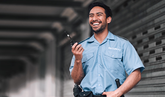 Security guard, safety officer and man with walkie talkie on street for protection, patrol or watch. Law enforcement, laugh and duty with a crime prevention male worker in uniform for communication