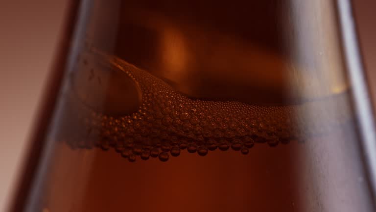 air bubbles in brown beer bottle in slow motion