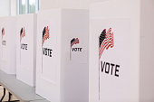 Voting booths printed with American flag set up in row