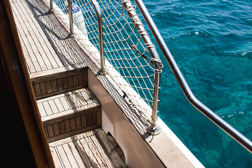 Boat deck with wooden floorings and sea