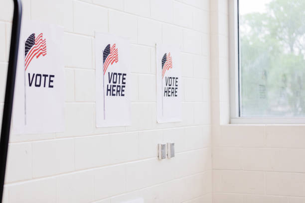 istock White cement wall with voting signs at polling place 1592139804
