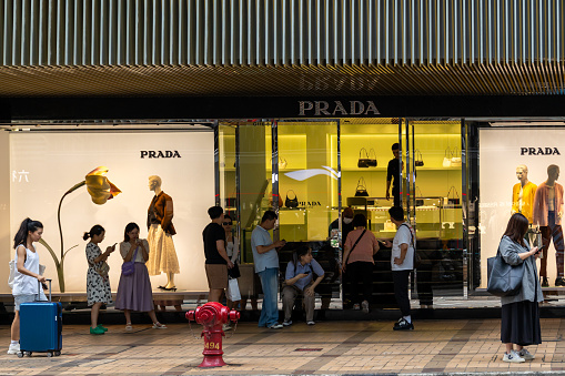 Hong Kong - August 4, 2023 : People queuing at Prada flagship store in Canton Road, Tsim Sha Tsui, Hong Kong.