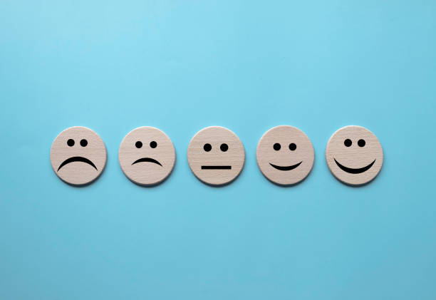 istock Concept of Customer Satisfaction Survey, user rate, service evaluation. Face expression on wooden circle. 1592177352