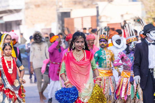 Bikaner, Rajasthan, India - January 2023: Camel festival bikaner, Group of young beautiful girls in traditional dress and jewellery of rajasthan while participating in the parade of camel festival in bikaner city. Selective focus.