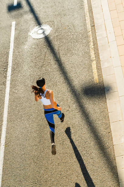 istock Young sporty looking woman running 1592186537