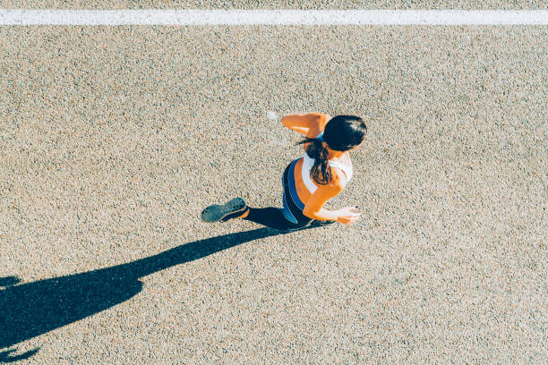 istock Young sporty looking woman running 1592187054
