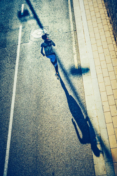 istock Young sporty looking woman running 1592187573