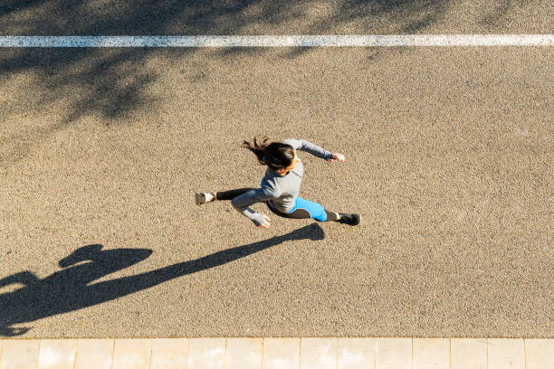 istock Young sporty looking woman running 1592187784