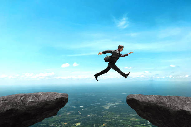 istock Businessman jumping on top mountain 3d illustration 1592197381