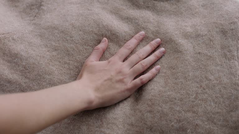 Hand, soft texture and wool material with cloth, textile and fabric count feel for winter and home. Cozy, cashmere and handmade knit in house with sheep, alpaca or hemp clothes materials of person