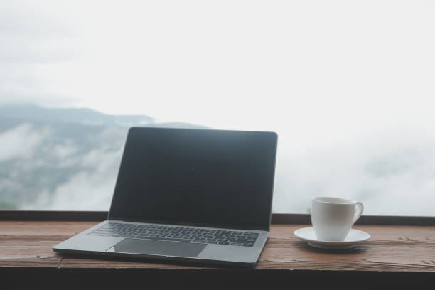 istock Young man freelancer traveler wearing hat anywhere working online using laptop and enjoying mountains view 1592210448