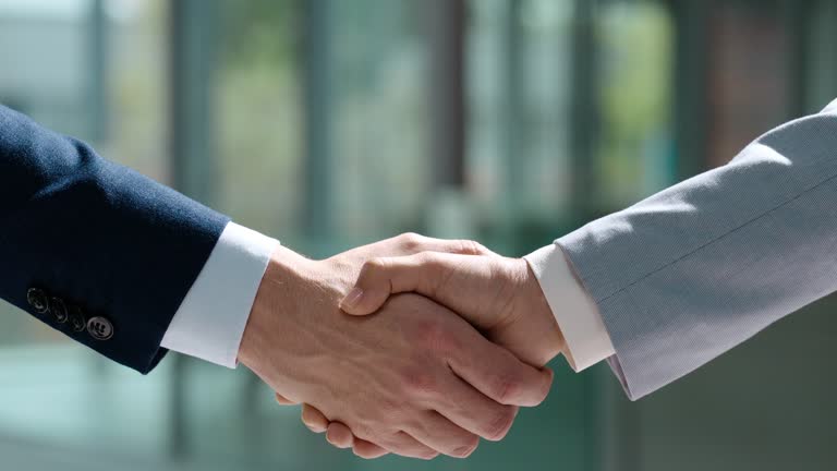 Business meeting, handshake and people in agreement, partnership or b2b collaboration from corporate networking. Shaking hands, together and staff welcome or team celebration of goal or achievement