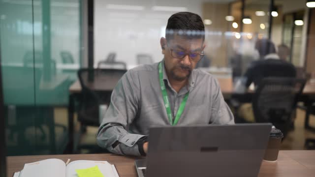 Mature man working using laptop in the office