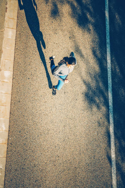 istock Young sporty looking woman running 1592224536