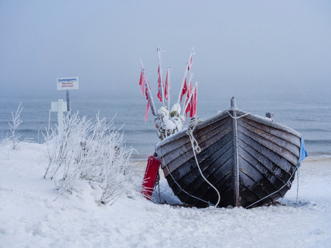 A fishing boat on shore of the Baltic Sea.