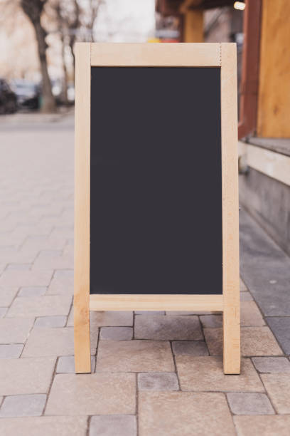 istock Mockup empty blank of cafe menu chalkboard on street - copy space and empty space for advertising mock-up 1592248722