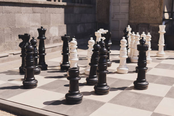 istock Giant chess on board located on ground outdoor - intellectual game 1592253636