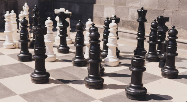 istock Giant chess on board located on ground outdoor - intellectual game 1592253653