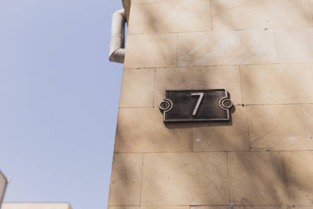istock House number seven 7 sign on stone wall 1592255222