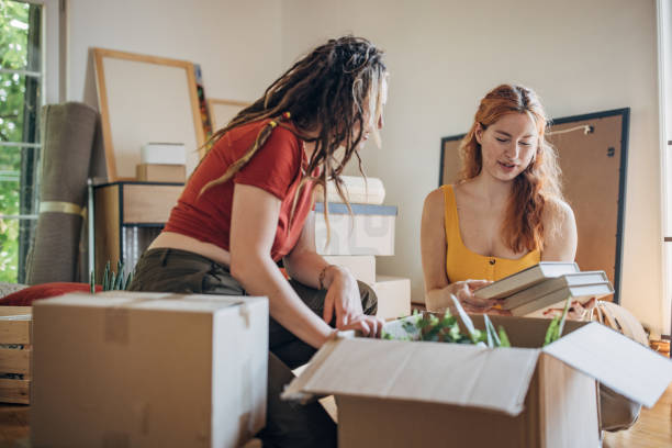 istock Lesbian couple moving in new home 1592298017