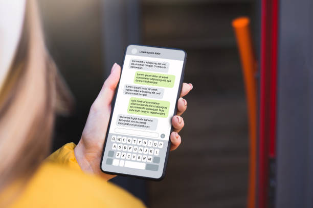 istock Woman texting with phone outdoors. Text message with smartphone 1592298542