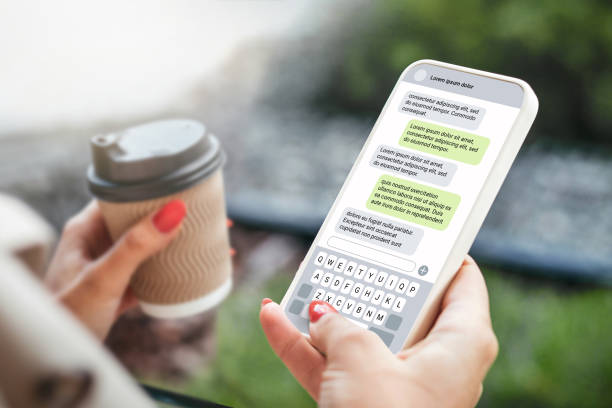istock Woman texting with phone outdoors. Text message with smartphone 1592298549