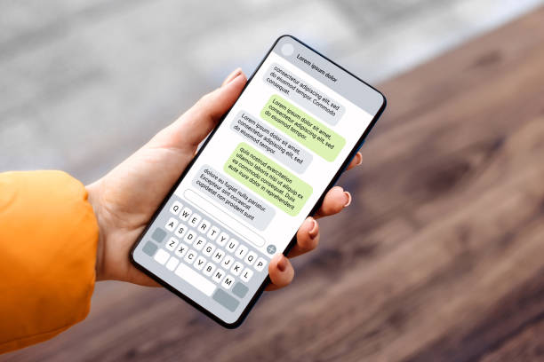 istock Woman holdind smartphone and texting outdoors. chatting with a phone 1592298554