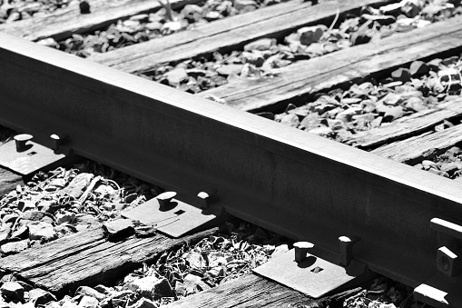 A close-up, Abstract and Semi surrealistic depiction of a railroad junction switch, shot in Late July, 2023, near an industrial park, in Dusseldorf, Germany.