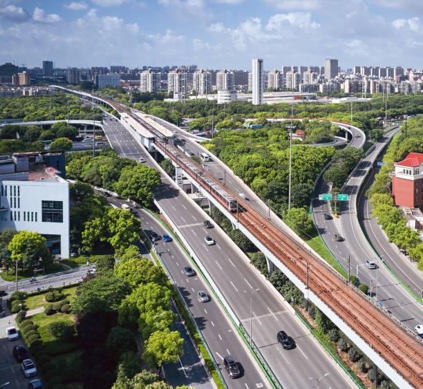 istock Light rail station and city elevated road in modern city 1592320152