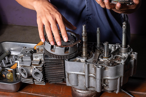 Part of motorcycle engine on a table in workshop