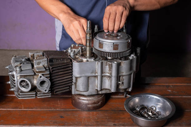 istock A man fixing a motorcycle motor in a garage,hands holding a cylinder, close-up 1592329966