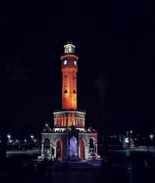 The historical Izmir clock tower illuminated in the darkness of the night. stock photo