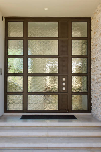 istock Contemporary modern design front door with side windows and wood trim 1592367627