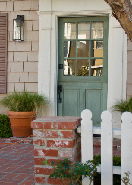 istock Old fashioned beach bungalow with brick patio and picket fence 1592369734