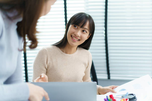 istock Female colleague talking together. 1592371838