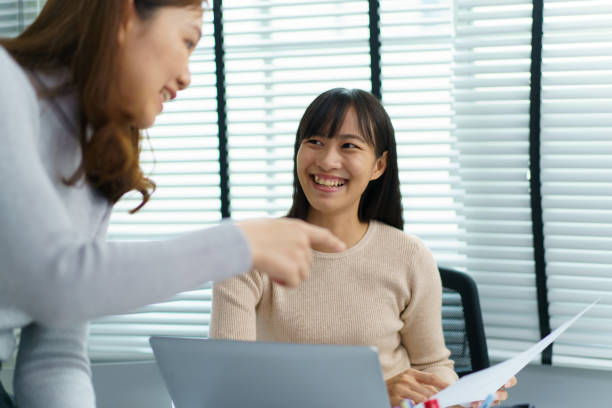 istock Female colleague talking together. 1592371842