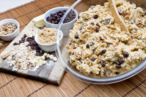 Chocolate Chip Cookie Ingredients including butter, oats and walnuts and measuring spoons
