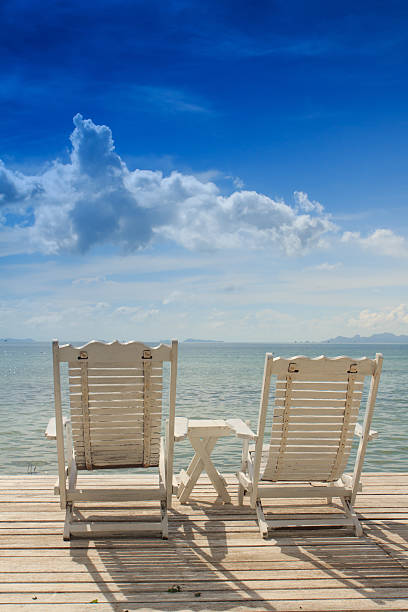 istock White wooden beach chair on terrace 159250844