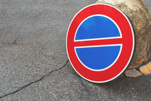 An Italian No Parking traffic sign on a street. Concept of safety on the streets, driving