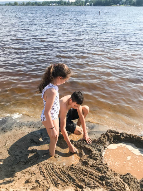 istock Brother and sister making castle sand 1592511685
