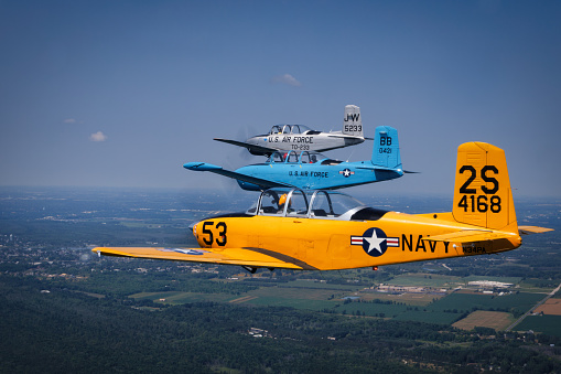 Two Rivers, Wisconsin, USA - July 21, 2023: Three Beechcraft T-34 Mentors in formation in the skies near Point Beach State Park.,