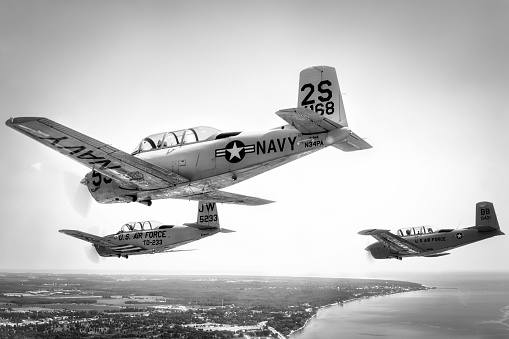 Manitowoc, Wisconsin, USA - July 21, 2023: A formation of three Beechcraft T-34 Mentors descend over Lake Michigan.