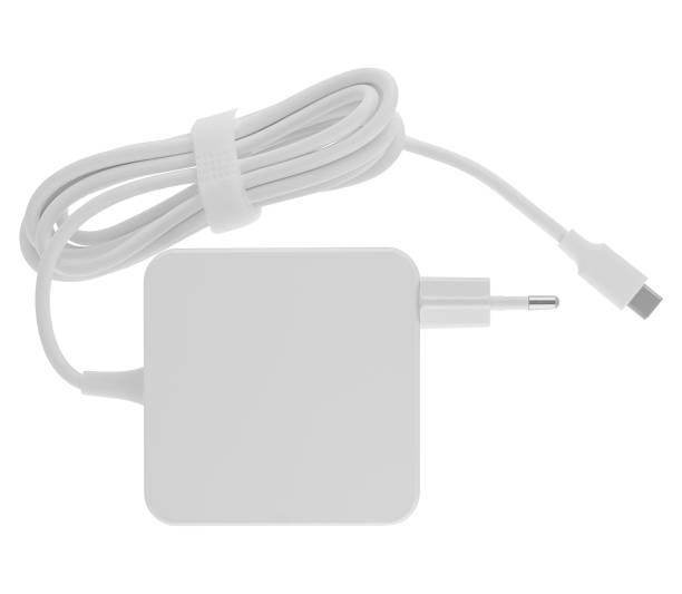 istock Laptop power adapter, computer spare part, on white background in insulation 1592537980