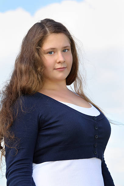 Feminine beauty concept. Portrait of beautiful young woman touching her long brown hair