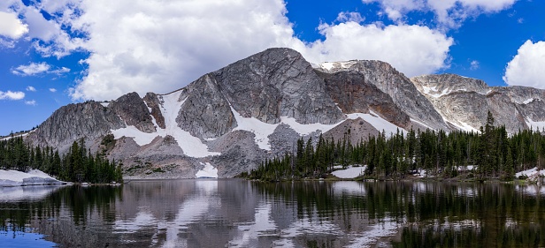 The Snowy Range mountains reflect off Lake Marie