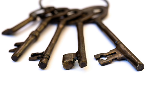Old set of five old keys, white background with copy space, full frame horizontal composition