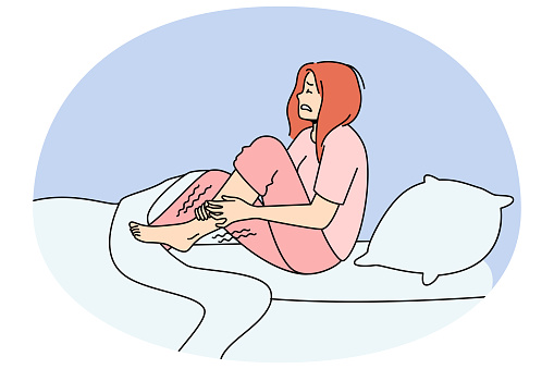 Unhappy woman in bed at night suffer from restless leg syndrome. Unhealthy female struggle with cramp. Healthcare concept. Vector illustration.