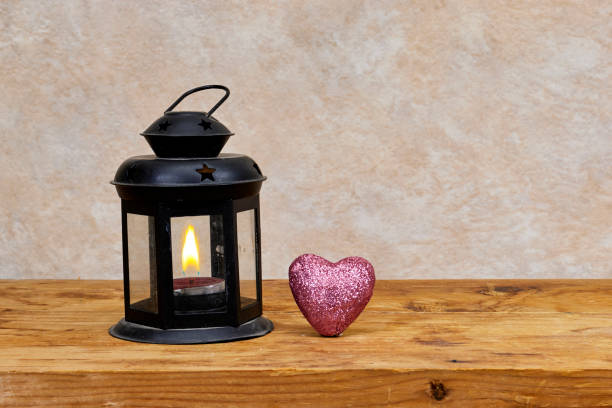 istock glow light lantern with heart glitter on wood table 1592609709