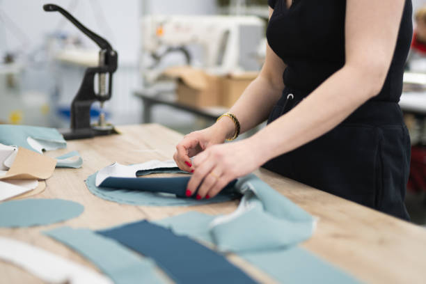 istock cutting of fabrics cut in production for sewing clothes 1592620894